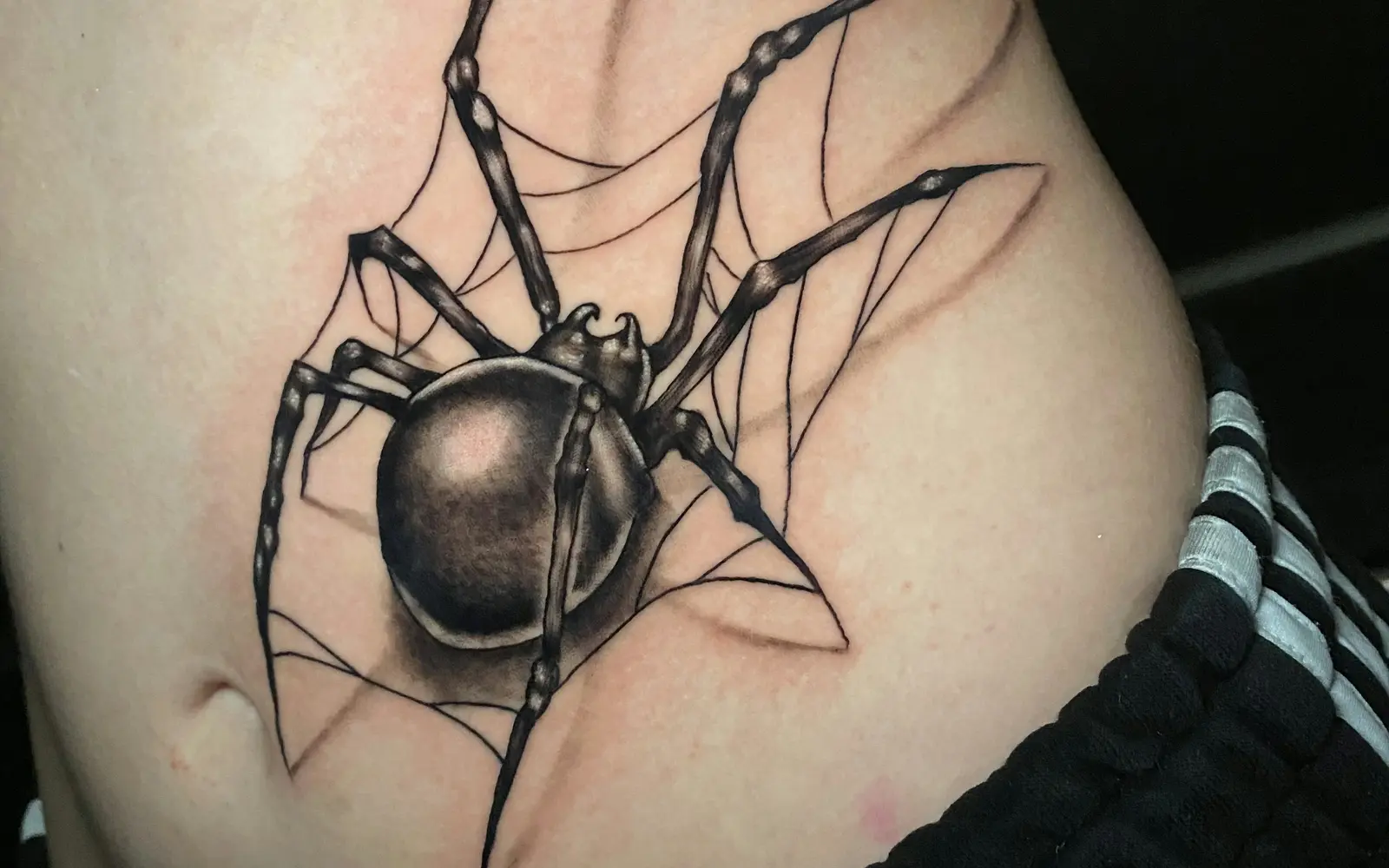 3D spider tattoo on stomach