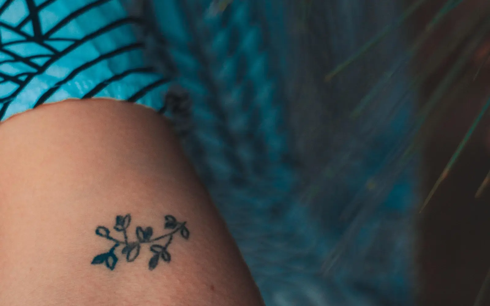 Close-up fine-line floral tattoo