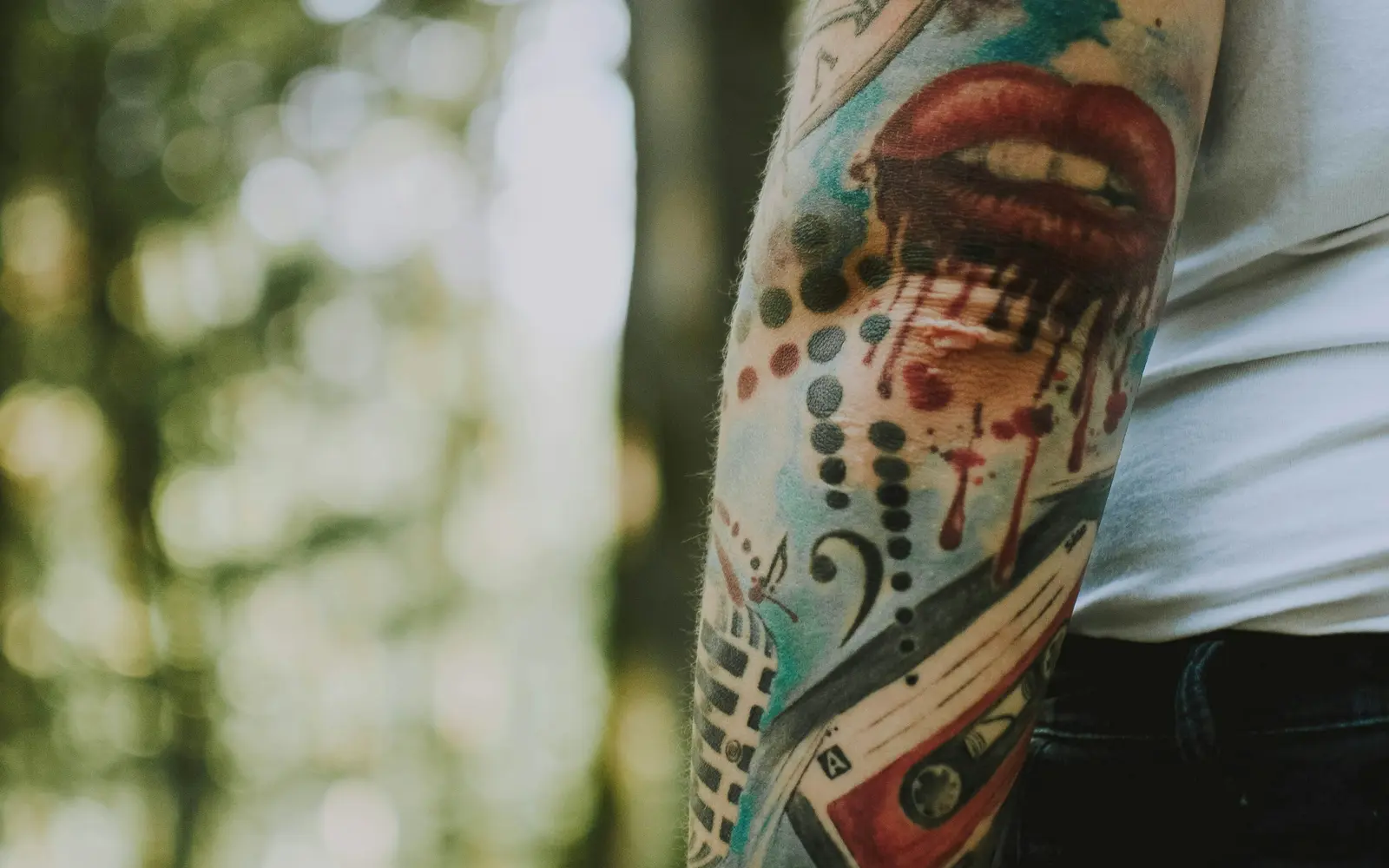 Musical themed old school tattoo on arm